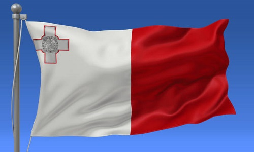 Malta flag waving on the flagpole on a sky background